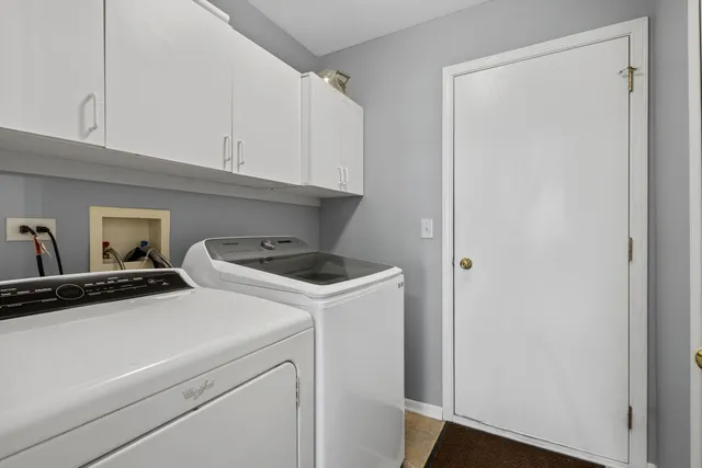 a bedroom with a bed a couch and large window