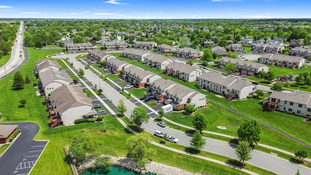 an aerial view of a residential houses with outdoor space and street view