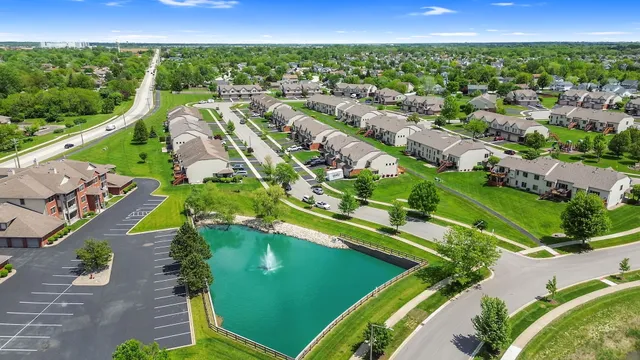 an aerial view of a house with garden space ocean and mountain view in back