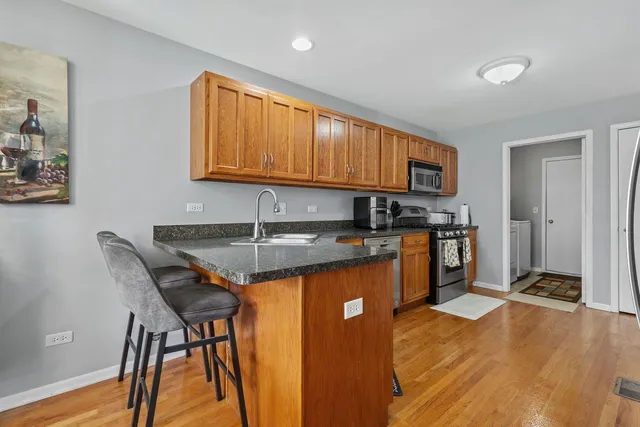 a kitchen with stainless steel appliances granite countertop a refrigerator and a stove top oven