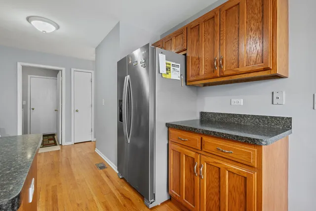 a kitchen with stainless steel appliances granite countertop a stove a sink dishwasher and a refrigerator