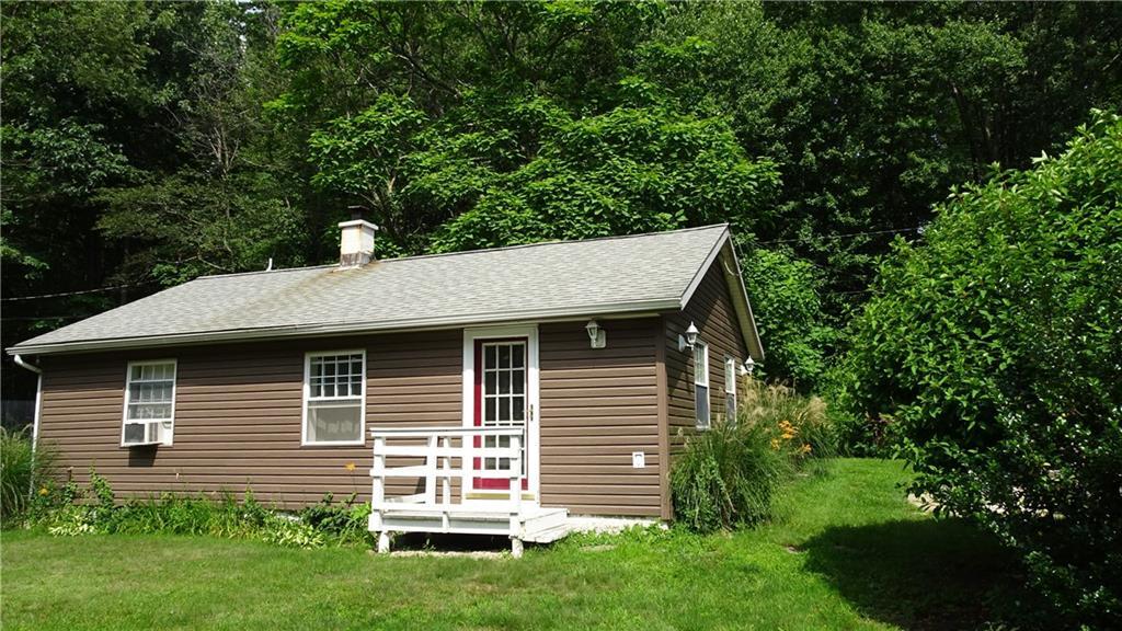 24 Box Mountain Road Bolton, CT 06043 - Photo 1 of 1 a backyard of a house with plants and large tree