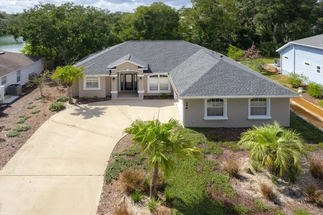 an aerial view of a house with a lake view