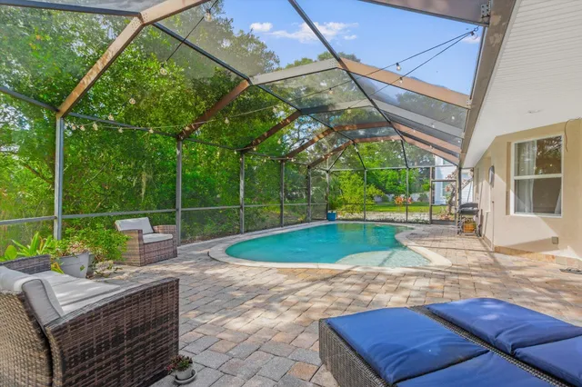 a view of a house with backyard porch and sitting area