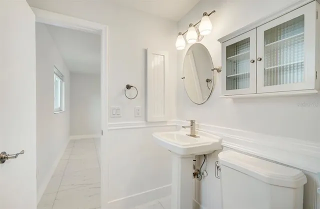a bathroom with a sink mirror and vanity