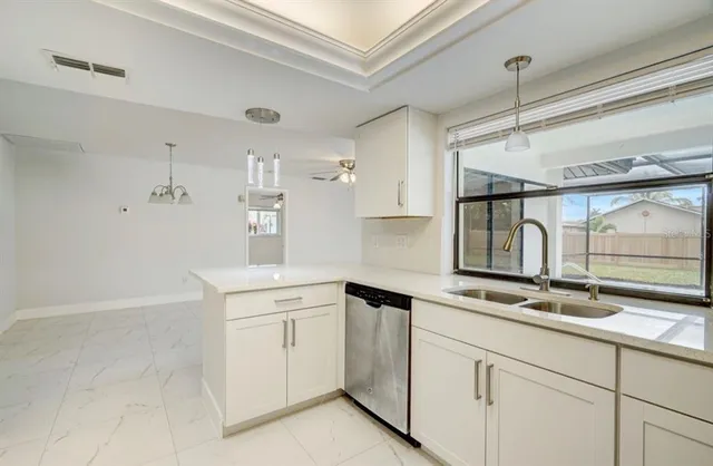 a kitchen with white cabinets and white appliances