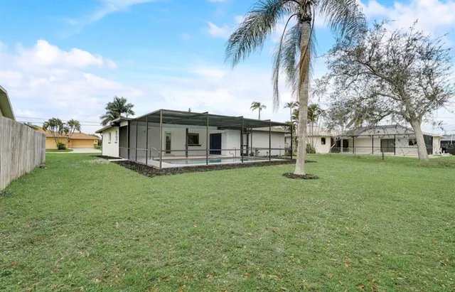 a view of a house with a backyard