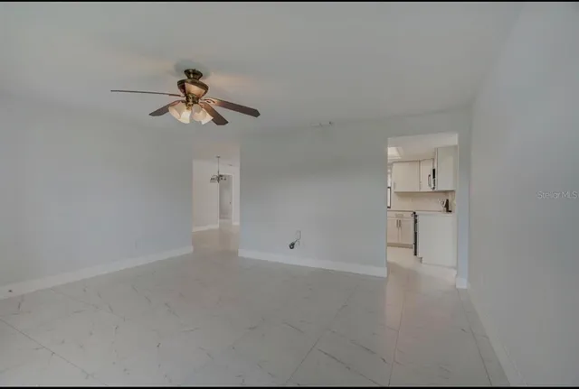 a view of room with a ceiling fan and window