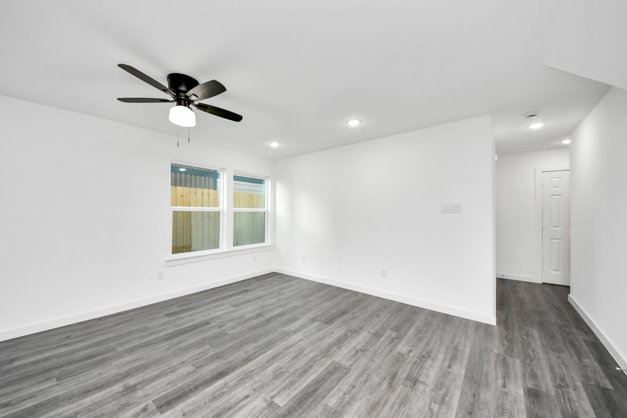 2310 Wavell Street, Unit B Houston, TX 77088 - Photo 16 of 37 a view of empty room with wooden floor and fan