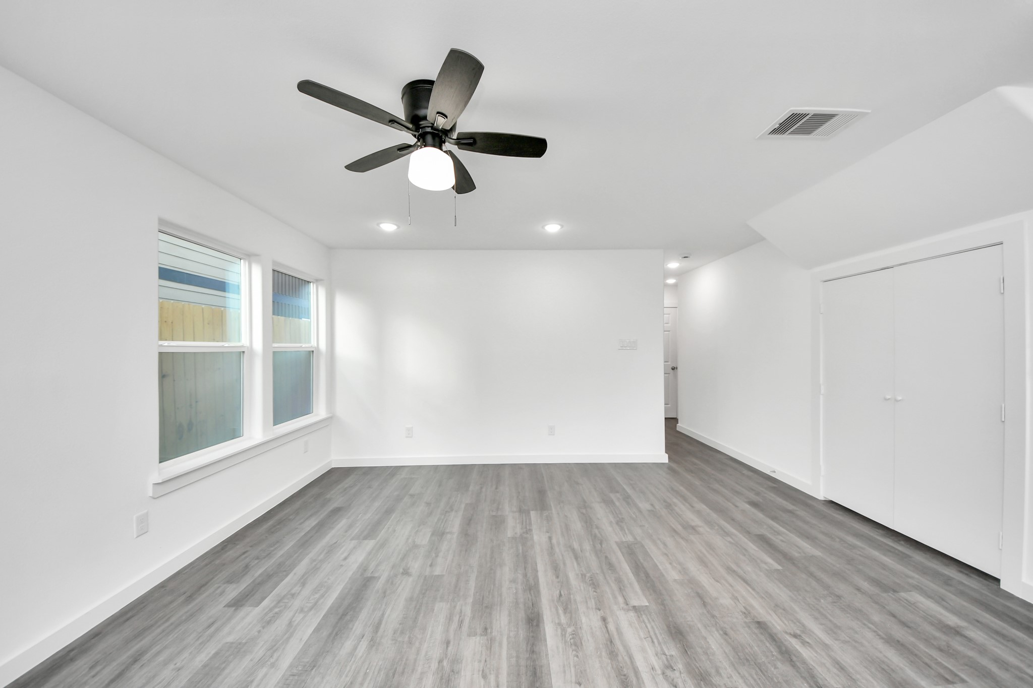 2310 Wavell Street, Unit B Houston, TX 77088 - Photo 17 of 37 a view of empty room with wooden floor and fan