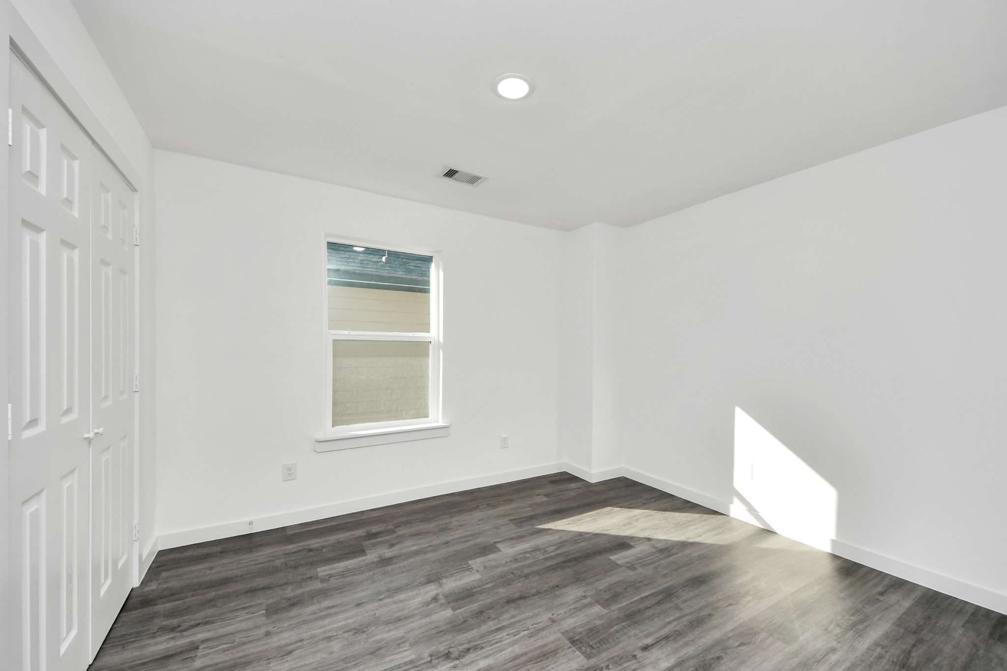 2310 Wavell Street, Unit B Houston, TX 77088 - Photo 24 of 37 an empty room with wooden floor and windows