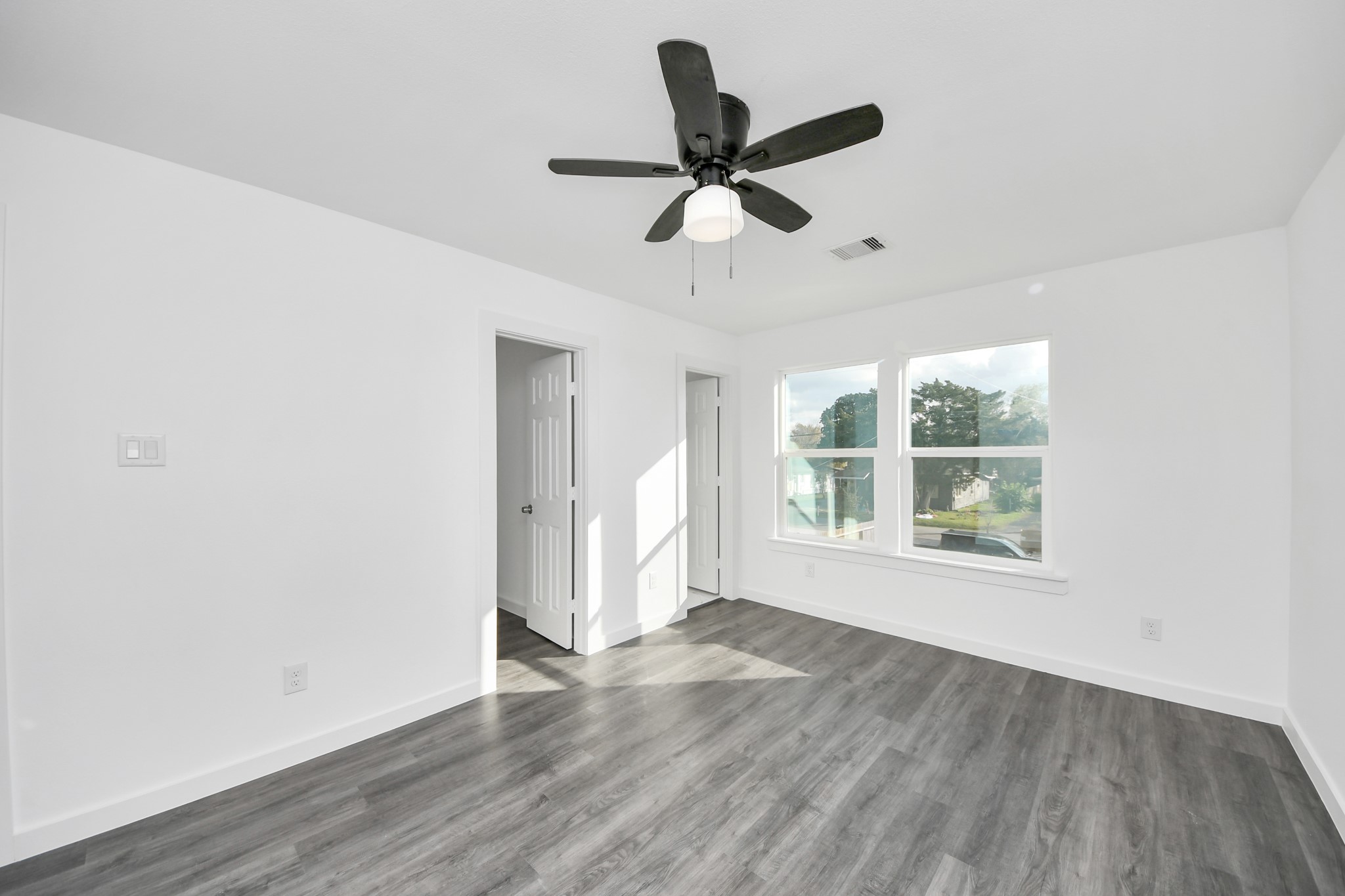 2310 Wavell Street, Unit B Houston, TX 77088 - Photo 27 of 37 a view of empty room with wooden floor and fan