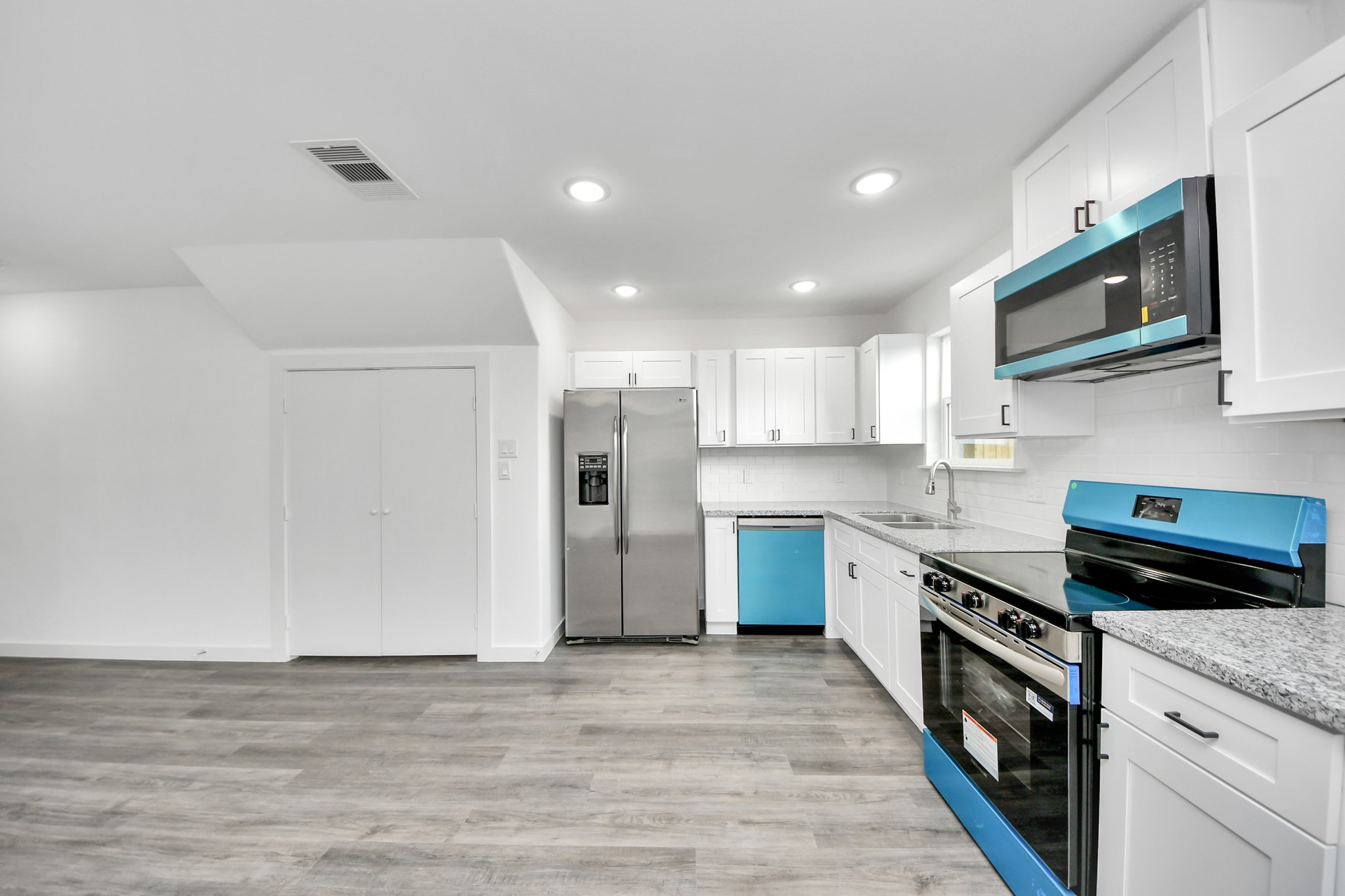 2310 Wavell Street, Unit B Houston, TX 77088 - Photo 8 of 37 a kitchen with stainless steel appliances granite countertop a stove top oven a sink and a refrigerator
