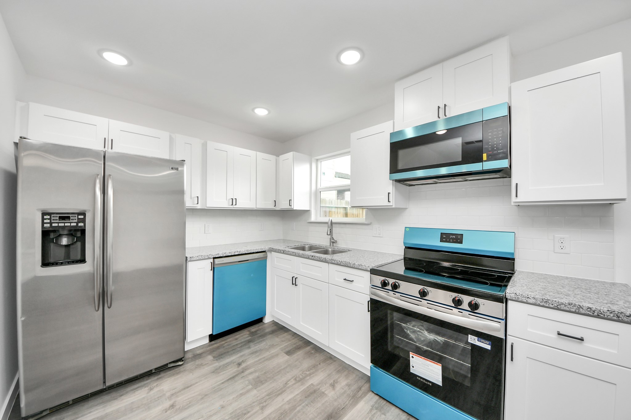 2310 Wavell Street, Unit B Houston, TX 77088 - Photo 9 of 37 a kitchen with stainless steel appliances white cabinets and a stove top oven