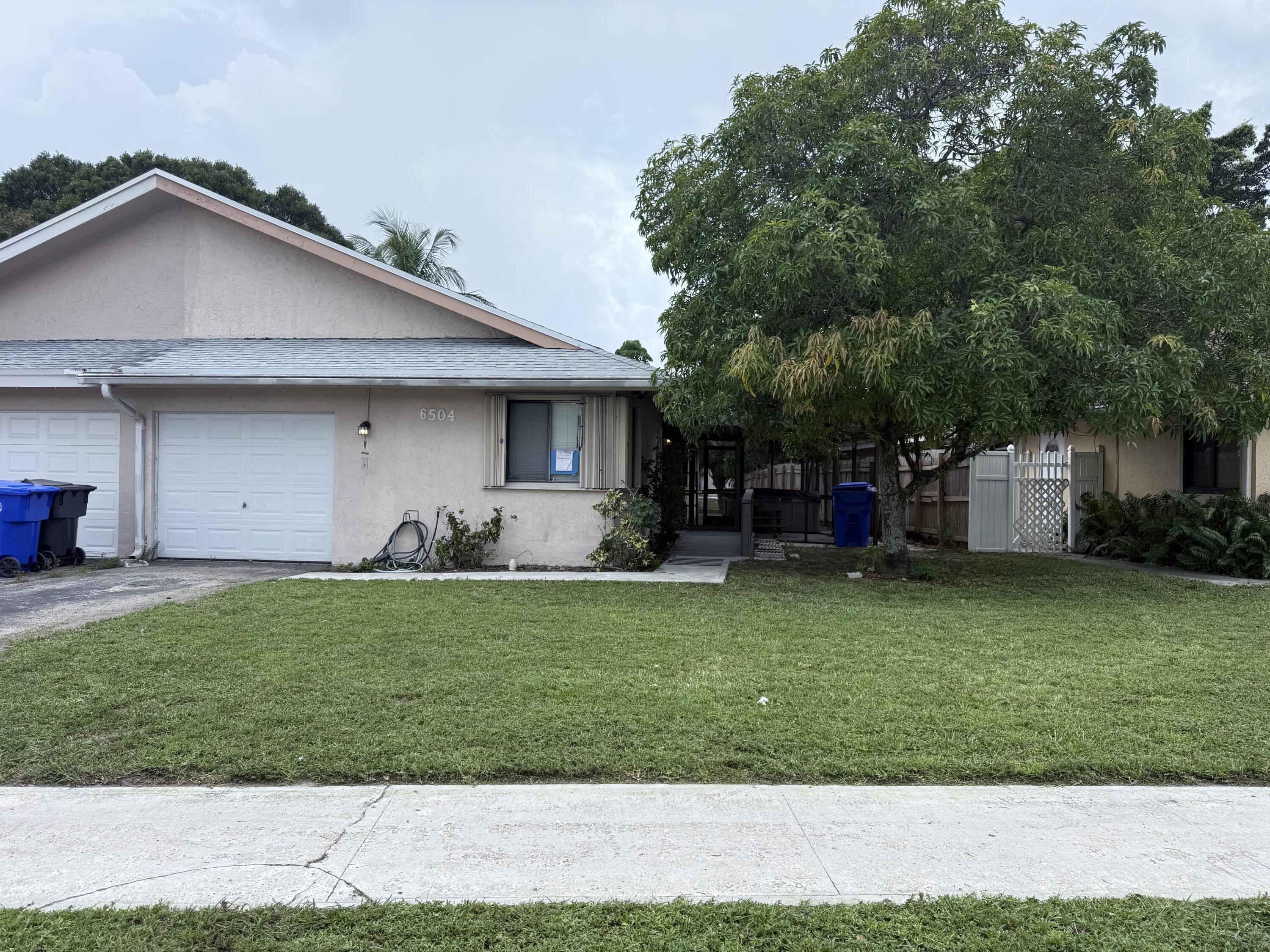 6504 Harbour Road North Lauderdale, FL 33068 - Photo 1 of 15 a front view of a house with a yard and garage