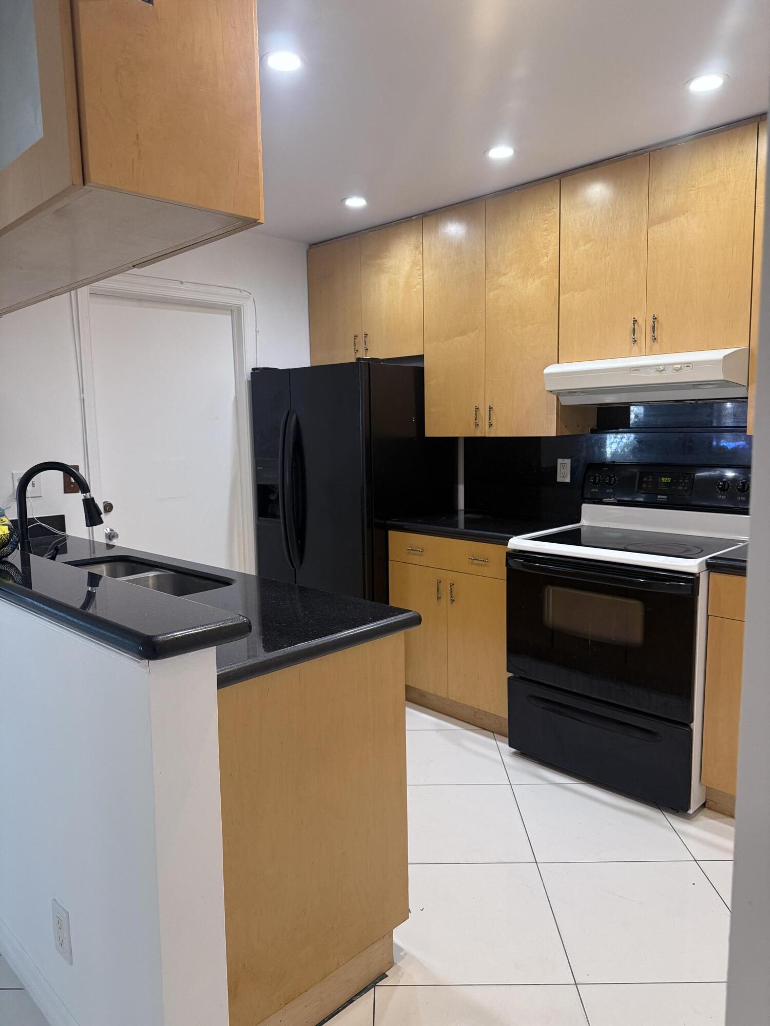 6504 Harbour Road North Lauderdale, FL 33068 - Photo 2 of 15 a kitchen with stainless steel appliances a stove a microwave and a refrigerator