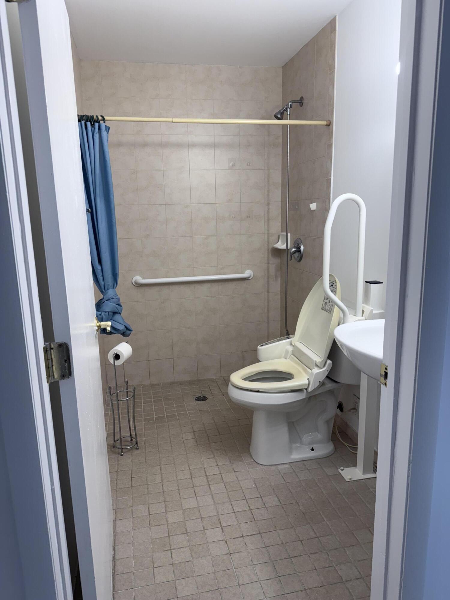 6504 Harbour Road North Lauderdale, FL 33068 - Photo 7 of 15 a white toilet sitting next to a bathroom sink
