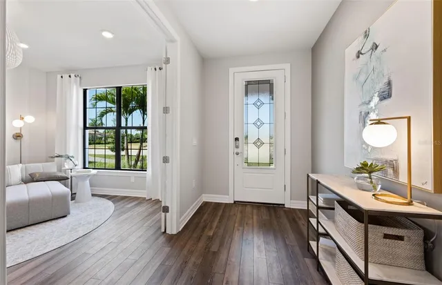 view of hall way with furniture and wooden floor