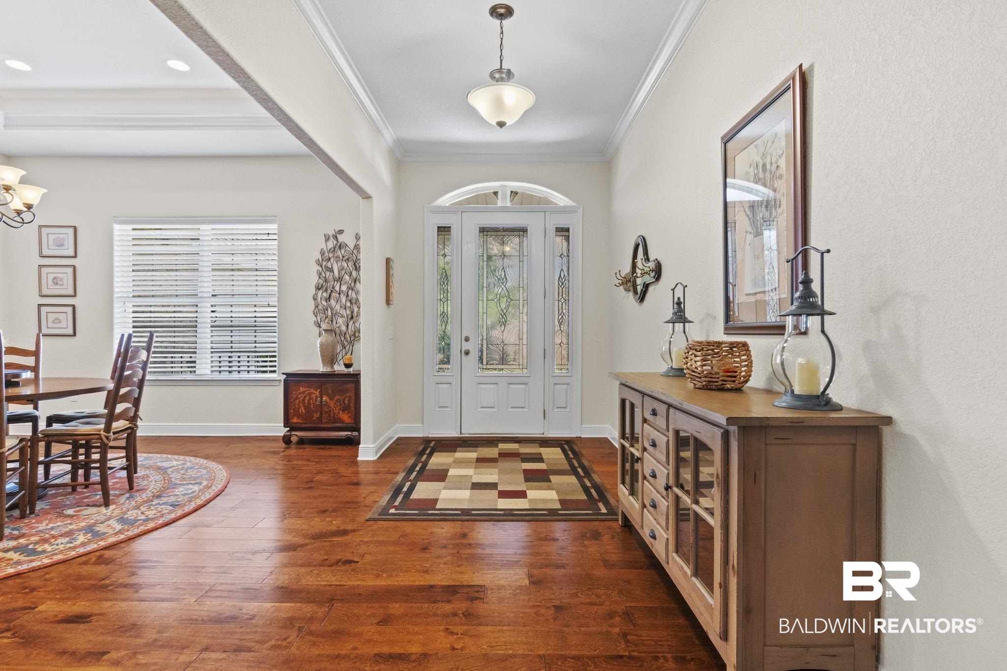 8664 Foxtail Loop Pensacola, FL 32526 - Photo 5 of 64 Entryway featuring plenty of natural light, a chandelier, ornamental molding, dark wood-style floors, and baseboards