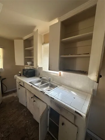 a kitchen with a sink and a stove