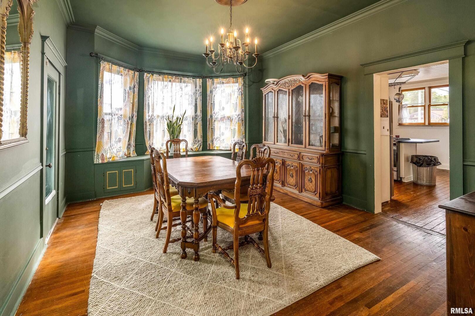 2101 Walnut Street Murphysboro, IL 62966 - Photo 14 of 55 a dining room with furniture a chandelier and wooden floor