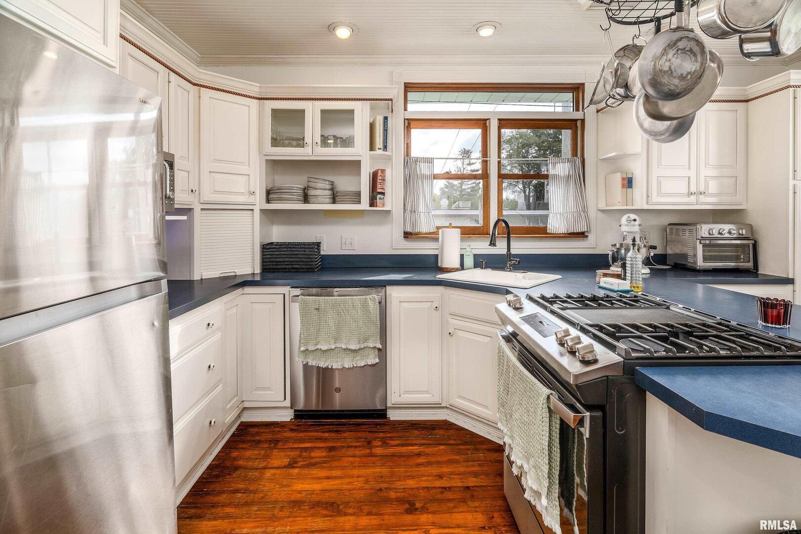 2101 Walnut Street Murphysboro, IL 62966 - Photo 16 of 55 a kitchen with a stove a sink and a refrigerator
