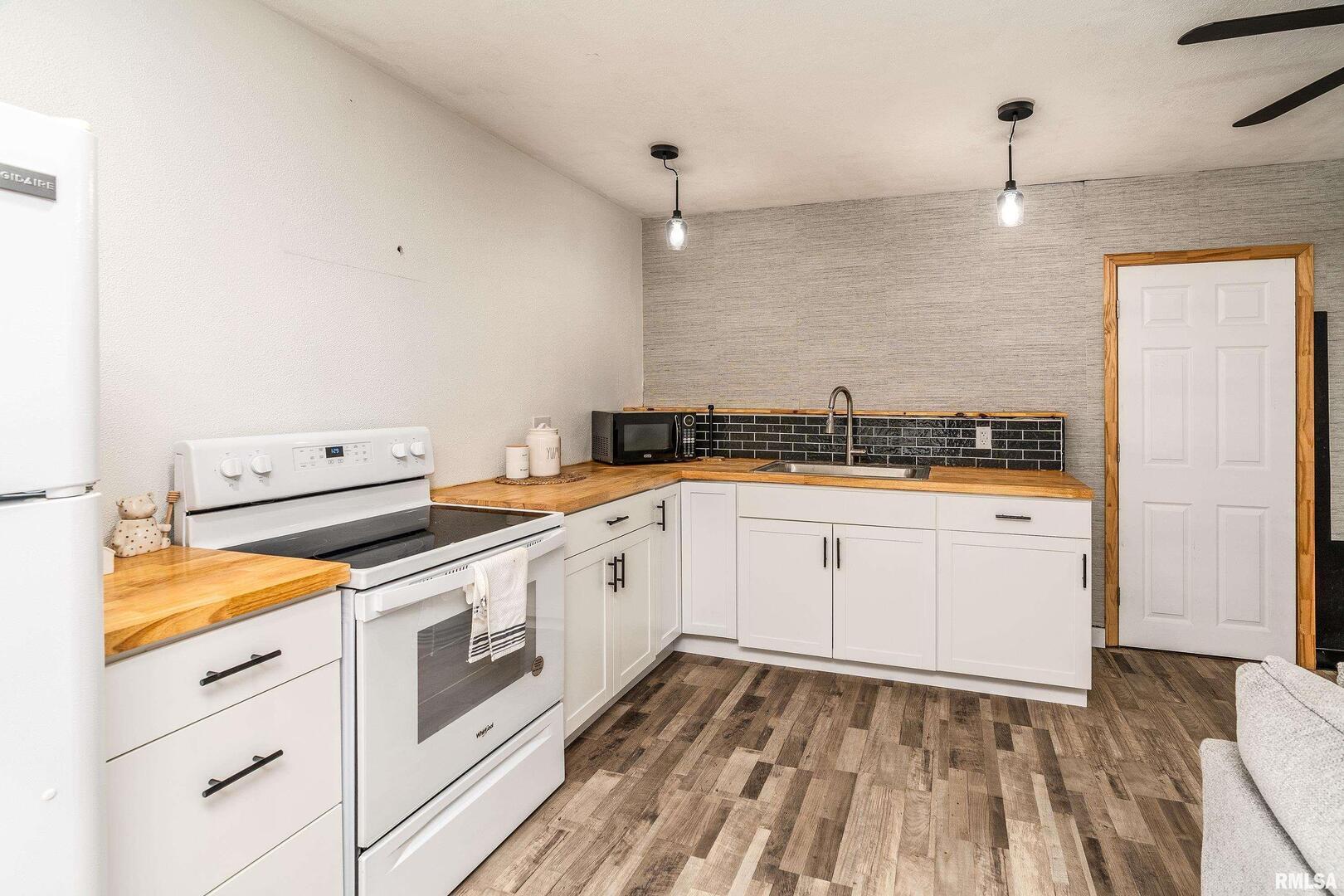 2101 Walnut Street Murphysboro, IL 62966 - Photo 43 of 55 a kitchen with granite countertop white cabinets and white appliances