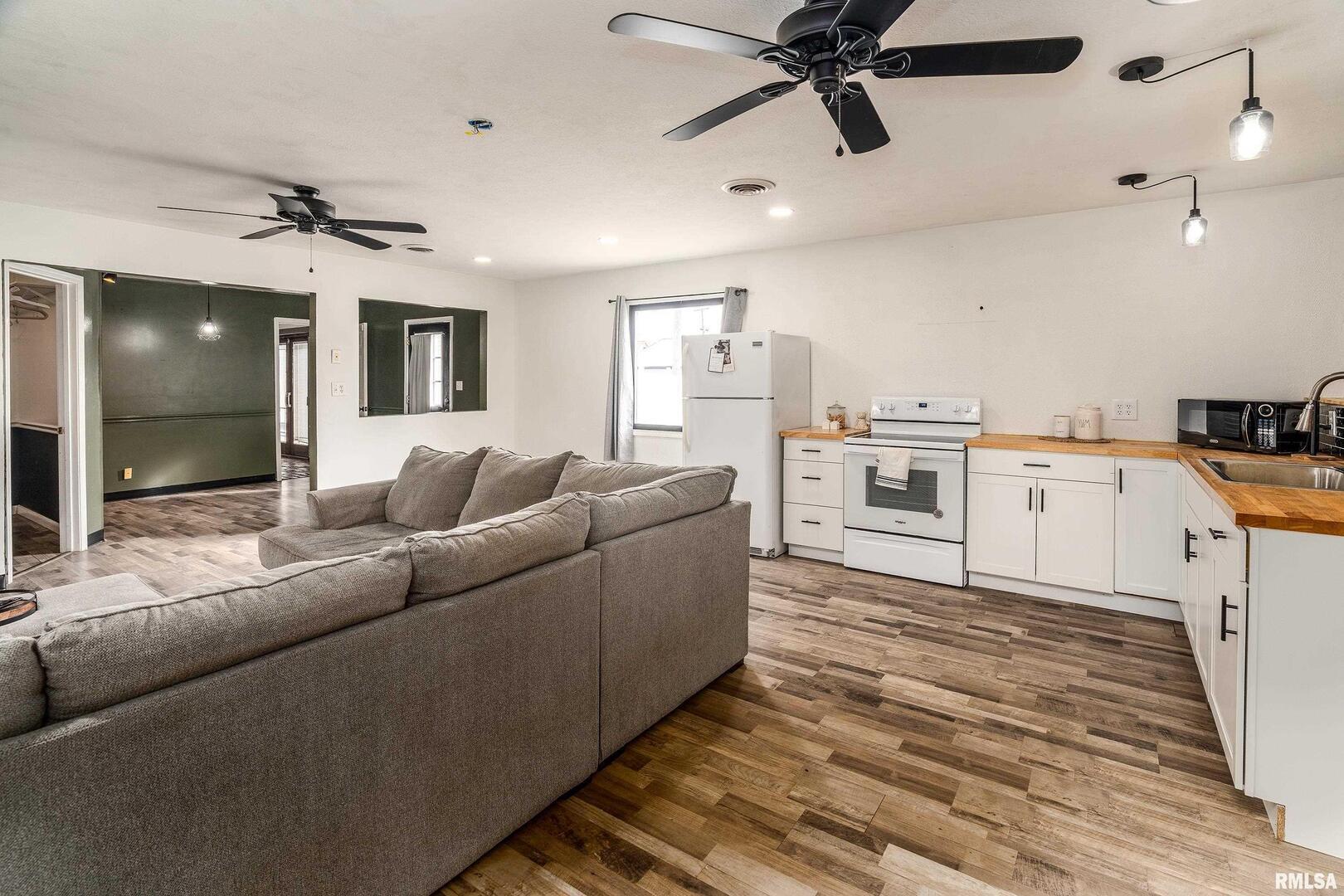 2101 Walnut Street Murphysboro, IL 62966 - Photo 44 of 55 a living room with kitchen island furniture and a ceiling fan