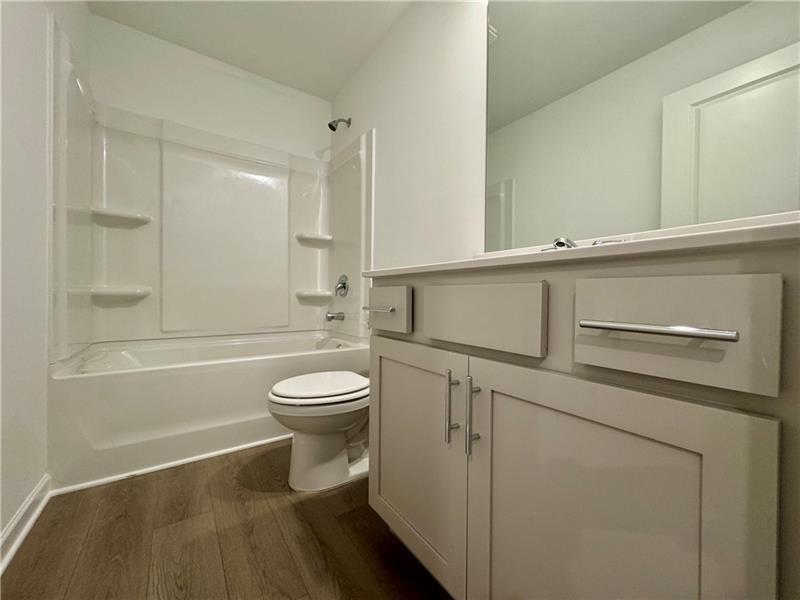 5309 Frontier Court Flowery Branch, GA 30542 - Photo 20 of 30 a bathroom with a toilet a sink and bathtub