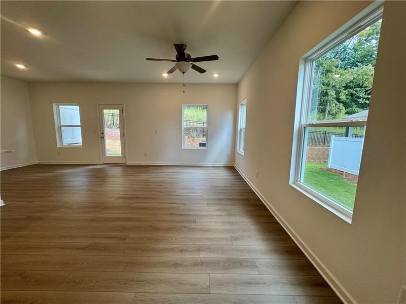 5309 Frontier Court Flowery Branch, GA 30542 - Photo 4 of 30 wooden floor in an empty room with a window