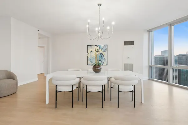 a view of a dining room with furniture wooden floor and chandelier