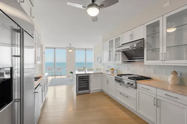 a kitchen with stainless steel appliances a stove sink and microwave