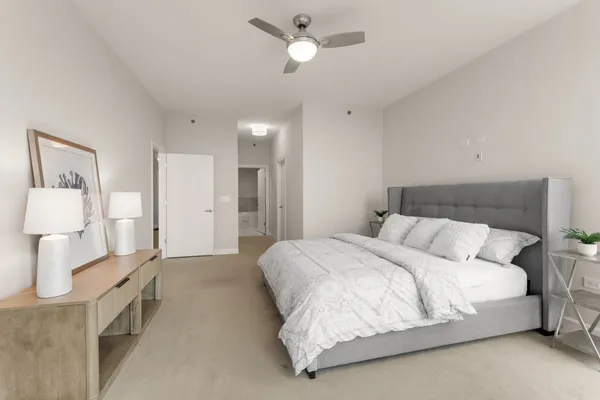 a bedroom with a bed and a lamp on table