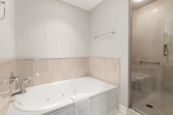 a bathroom with a white bath tub and shower