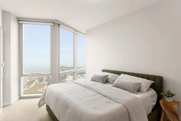 a bedroom with a large bed and a large window