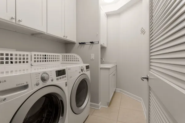 a view of washer and dryer with kitchen in the background