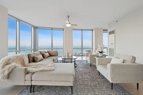 a living room with furniture and a chandelier