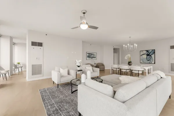 a living room with furniture and a chandelier