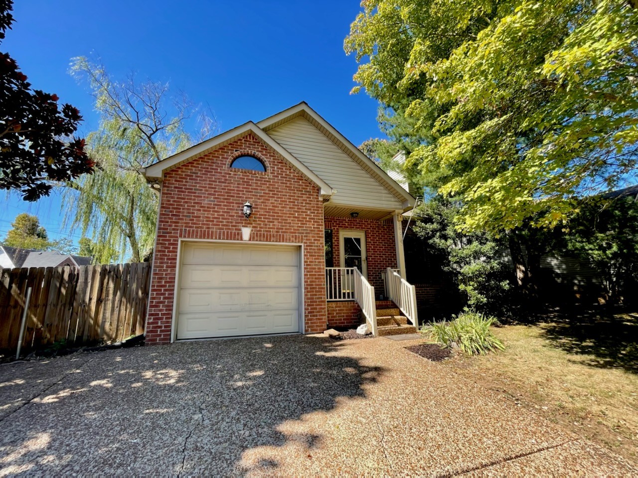 900 Dove Ridge Circle Nashville, TN 37221 - Photo 3 of 24 a front view of a house with a yard