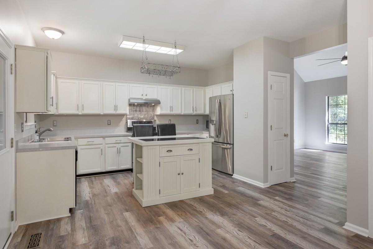 900 Dove Ridge Circle Nashville, TN 37221 - Photo 7 of 24 a kitchen with a white cabinets and wooden floor
