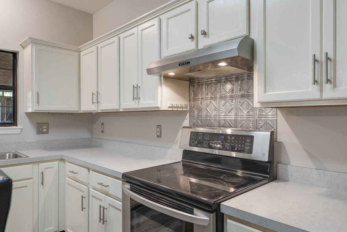 900 Dove Ridge Circle Nashville, TN 37221 - Photo 8 of 24 a kitchen with white cabinets and black appliances