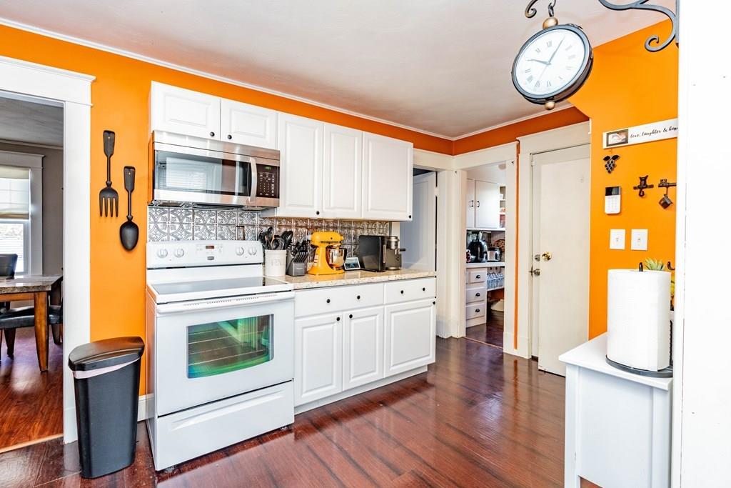 149 Eddy Street Springfield, MA 01104 - Photo 11 of 42 a kitchen with stainless steel appliances granite countertop a refrigerator a stove and a wooden floors