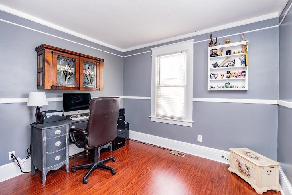 149 Eddy Street Springfield, MA 01104 - Photo 16 of 42 a workspace with wooden floor and a window