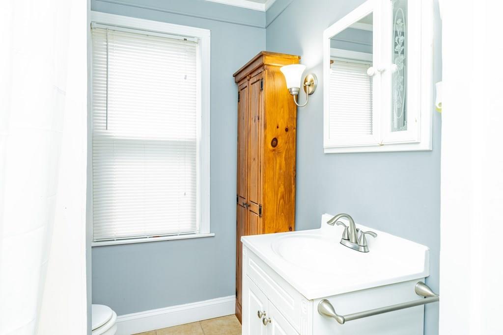 149 Eddy Street Springfield, MA 01104 - Photo 18 of 42 a bathroom with a sink and a mirror