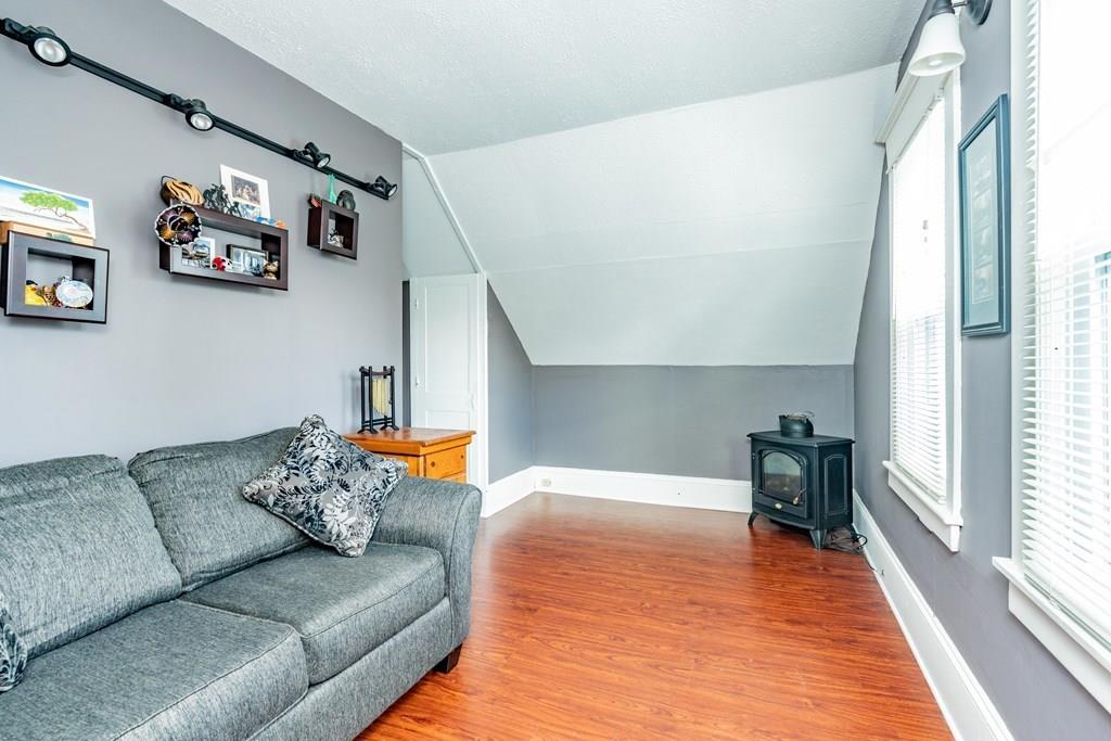 149 Eddy Street Springfield, MA 01104 - Photo 22 of 42 a living room with furniture and painting on the wall with a large window