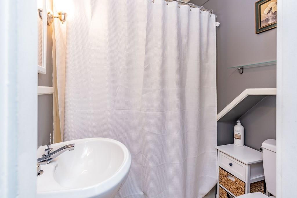 149 Eddy Street Springfield, MA 01104 - Photo 27 of 42 a bathroom with a sink a toilet and a mirror