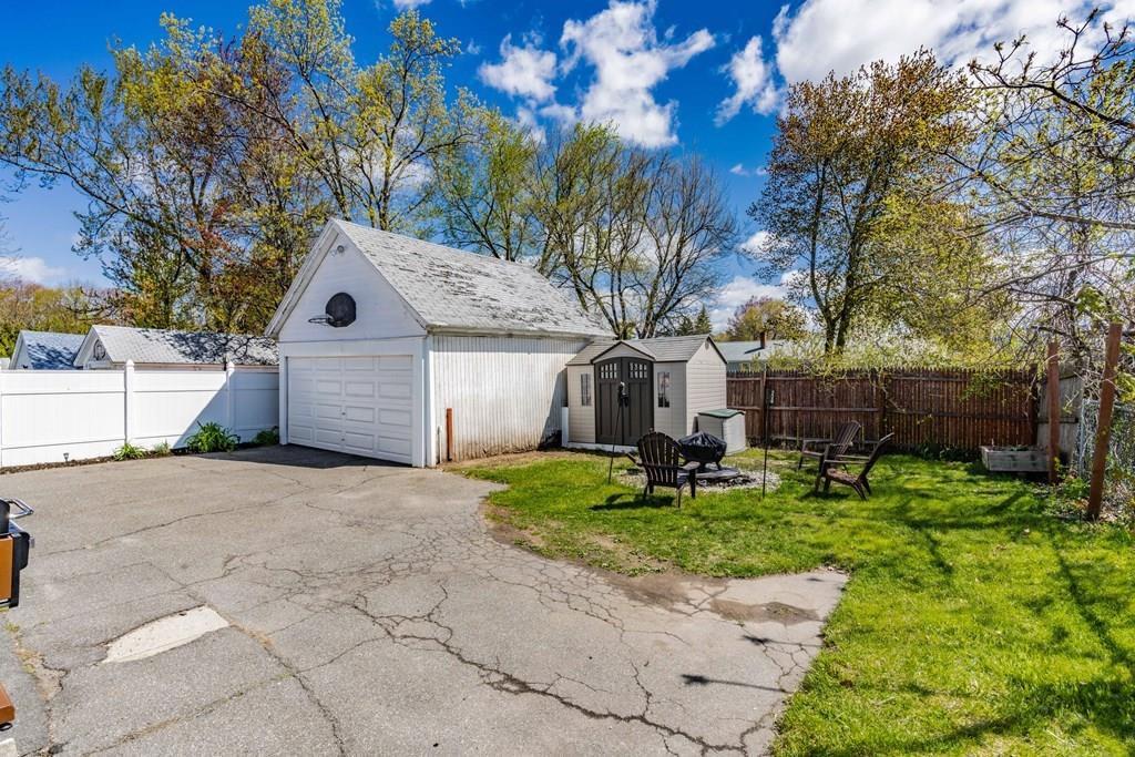 149 Eddy Street Springfield, MA 01104 - Photo 37 of 42 a front view of a house with a yard and garage
