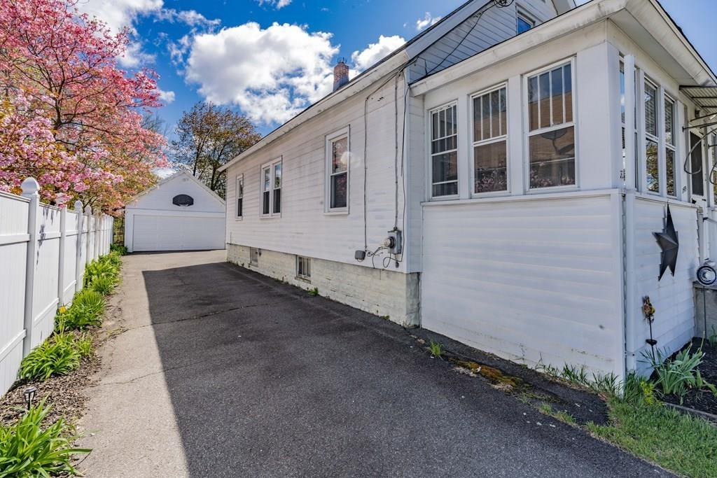 149 Eddy Street Springfield, MA 01104 - Photo 41 of 42 a front view of a house with a yard and garage