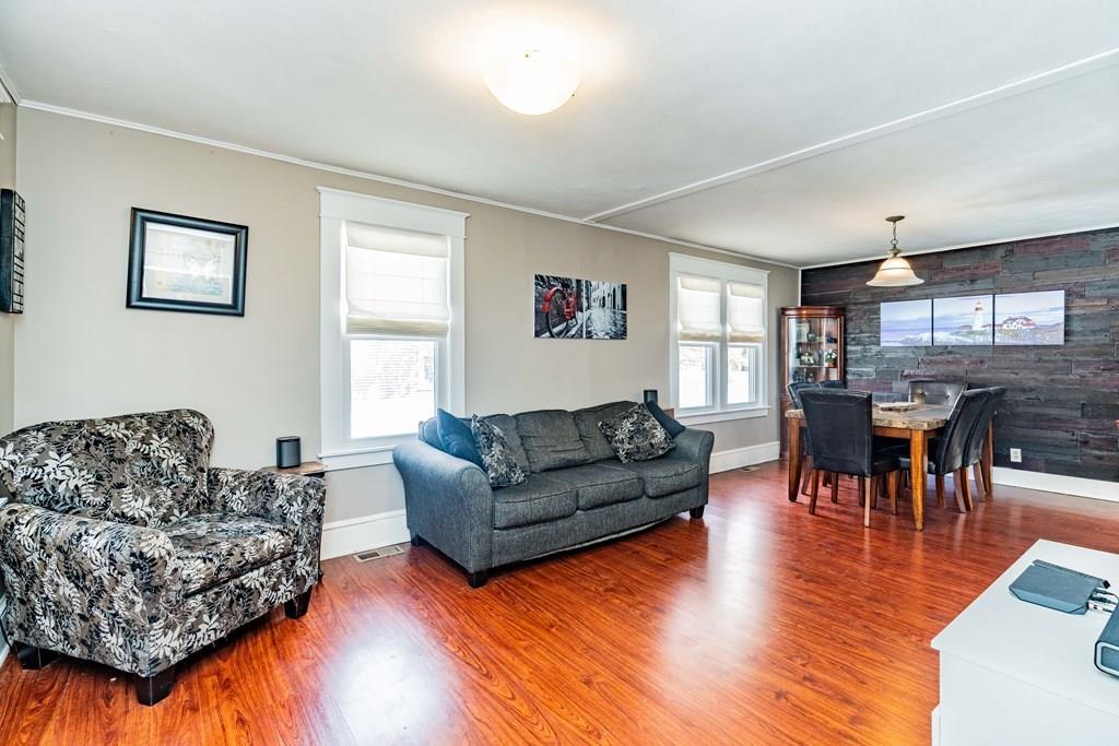 149 Eddy Street Springfield, MA 01104 - Photo 7 of 42 a living room with furniture and a dining table with wooden floor