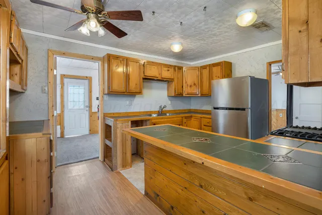 a kitchen with a refrigerator and a sink
